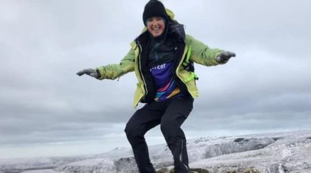 Amber Whewall smiling, stood on rocks