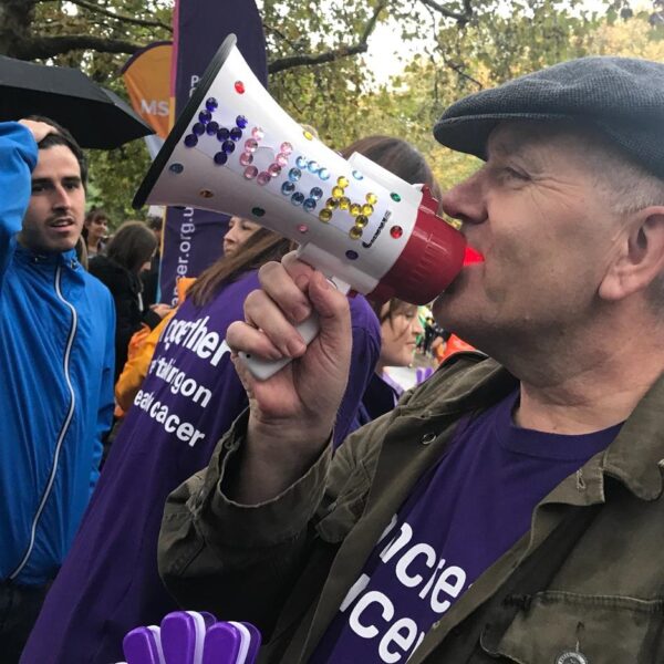 A PCUK supporter holding a megaphone