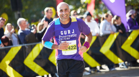 PCUK runner Gurj smiling and running the Royal Parks Half Marathon