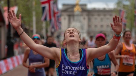 Ailsa with her hands in the air crossing the London Marathon finish line