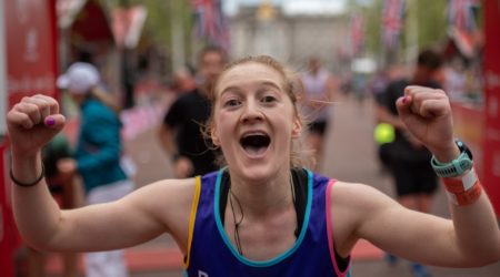 Ailsa with her hands in the air crossing the London Marathon finish line