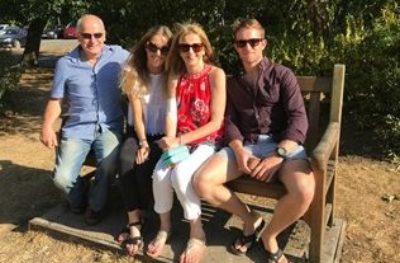 Kate, her husband, her daughter and son, sat on a park bench