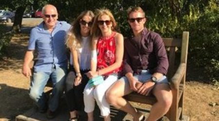 Kate, her husband, her daughter and son, sat on a park bench