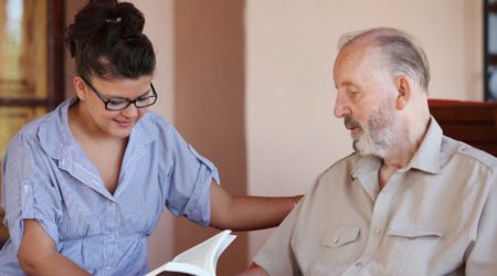 Nurse reading to a man