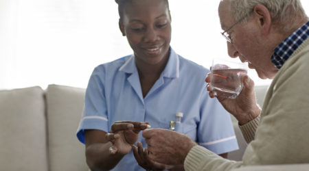 Female Doctor giving medication to a male patient