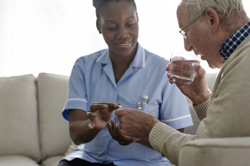 Female Doctor giving medication to a male patient