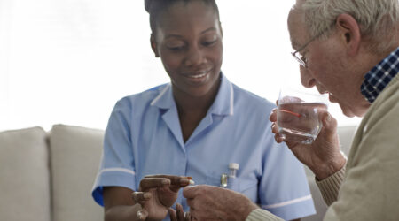 Female Doctor giving medication to a male patient