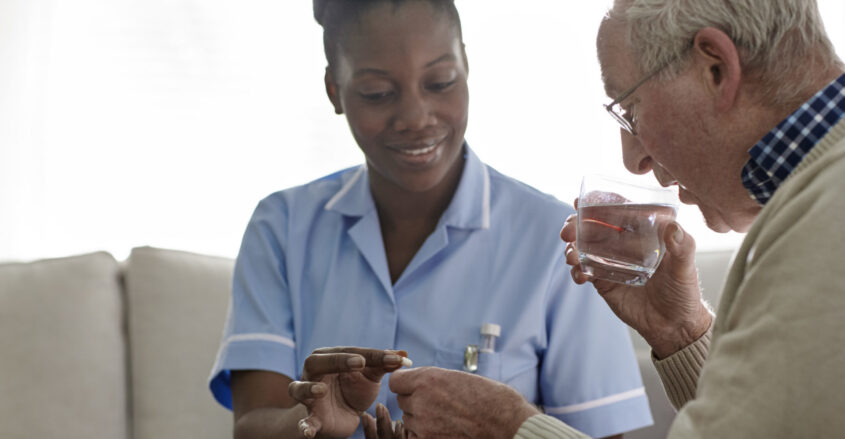 Female Doctor giving medication to a male patient