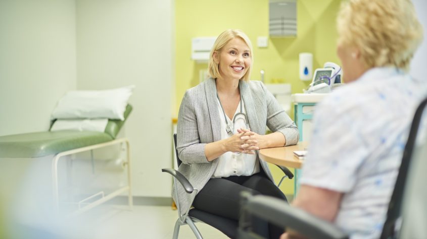 Female GP listening to patient