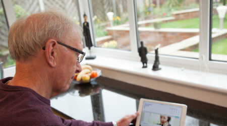 Man looking at his iPad, browsing PCUK website