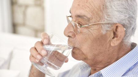 A man sips on water.