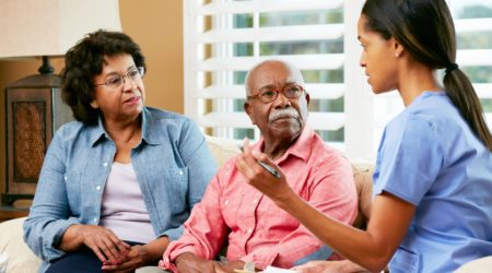 A nurse talking to couple