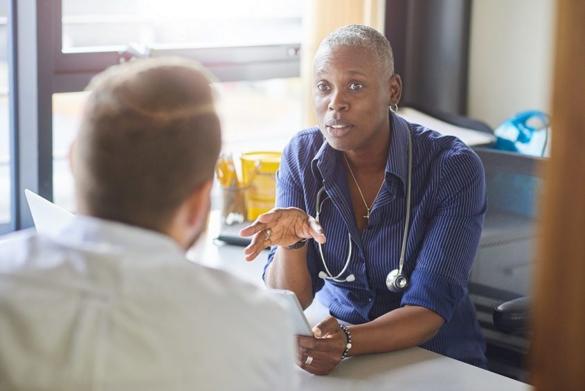 Doctor talking to male patient