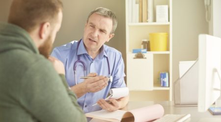 Man at medical appointment, speaking to his doctor