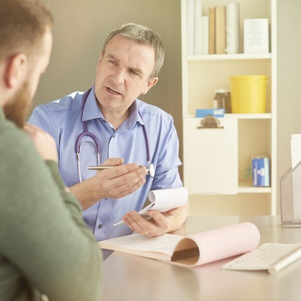 Man at medical appointment, speaking to his doctor