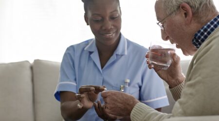 Female Doctor giving medication to a male patient