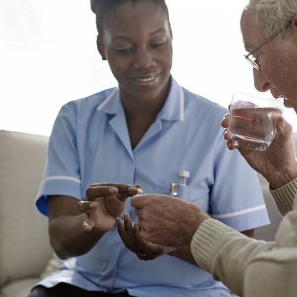 Female Doctor giving medication to a male patient