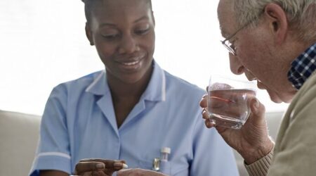 Female Doctor giving medication to a male patient