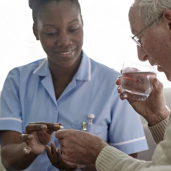Female Doctor giving medication to a male patient