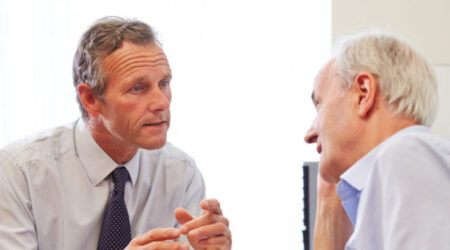 Senior Patient Having Consultation With Doctor In Office
