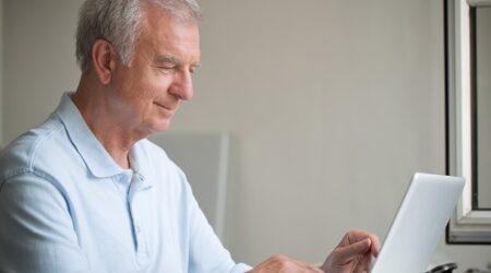Senior man sitting at laptop