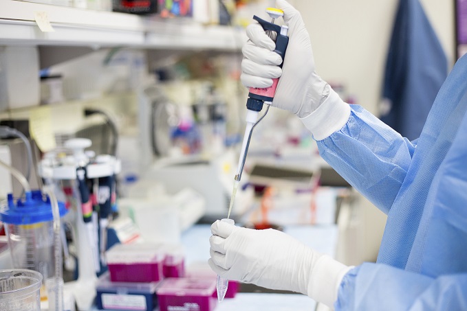 Scientist pipetting with hands in a laboratory