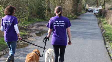 Couple walking with dogs