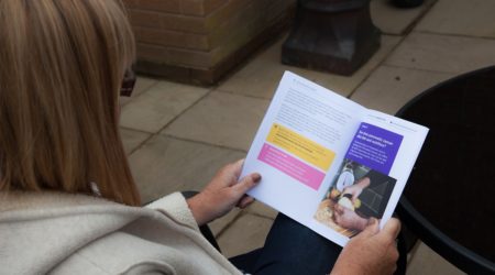 Image of a person reading a leaflet