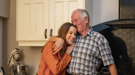 Grandfather with his arm around his granddaughter