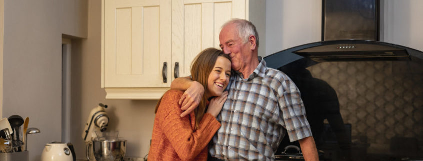 Grandfather with his arm around his granddaughter