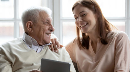 a man looking at a woman while pointing at a tablet