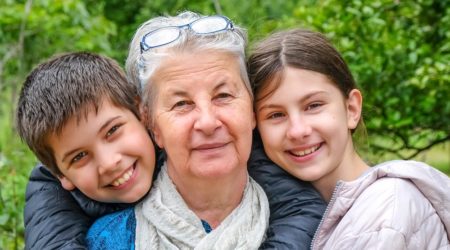 Two children and an older woman inbetween them