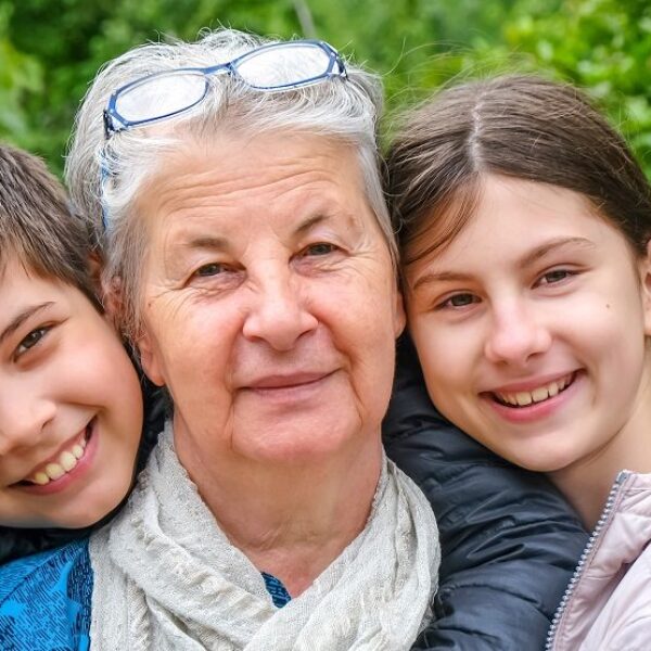 Two children and an older woman inbetween them