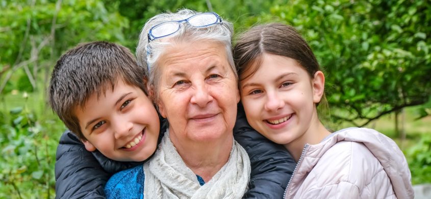 Two children and an older woman inbetween them