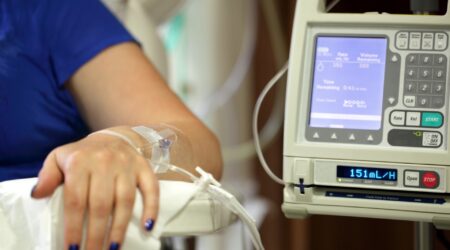 A machine delivering chemotherapy through an intravenous drip.
