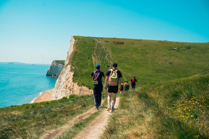 A group of people walking along the Jurassic coast