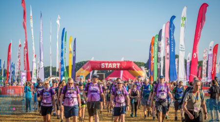Large group of people crossing the start line of the Jurassic Coast ultra challenge