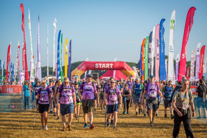 Large group of people crossing the start line of the Jurassic Coast ultra challenge