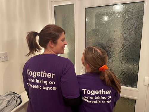 Amy with her daughter wearing tshirts saying 'Together, we'll take on pancreatic cancer'