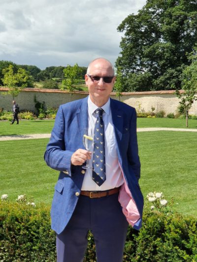 Charles Czaijkowski wearing a suit and smiling