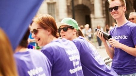 Group of people wearing pancreatic cancer UK t-shirts facing away from camera smiling