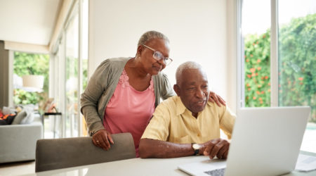 Couple reading information on a laptop