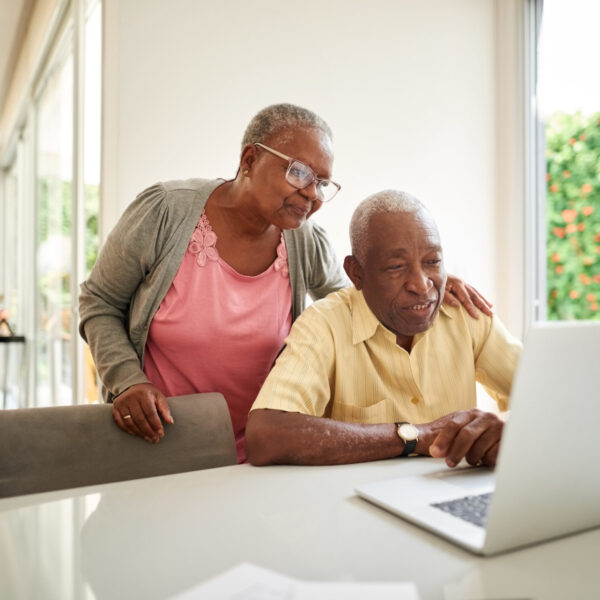 Couple reading information on a laptop