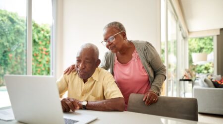 Couple reading information on a laptop