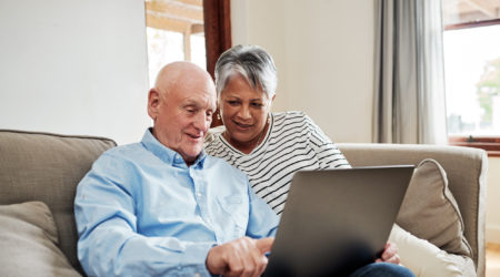 Couple use a laptop together