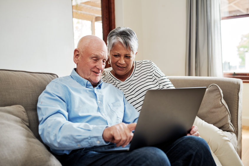 Couple use a laptop together