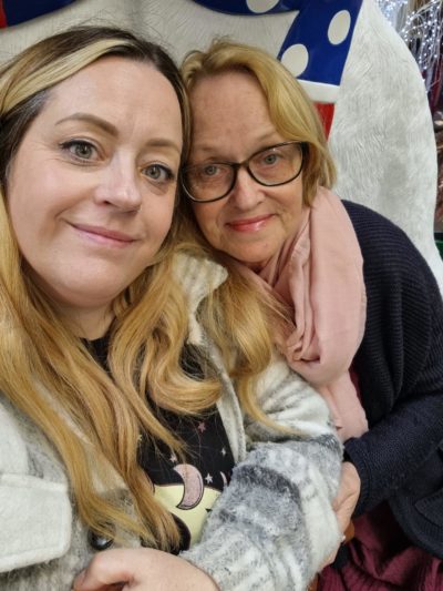 Two women, one young and one older, pose for a selfie