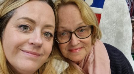 Two women, one young and one older, pose for a selfie