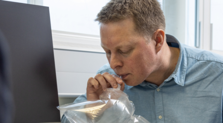 A man blowing into a bag as part of a breath test for pancreatic cancer