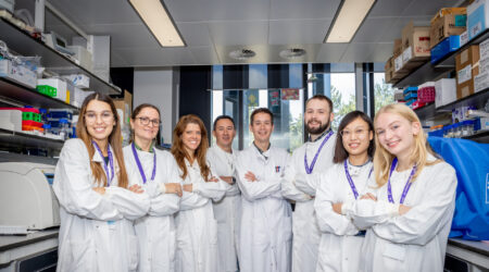 a group of lab workers having a photo taken for pancreatic cancer uk